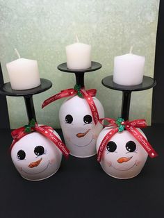 three snowman candles sitting on top of each other