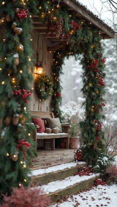 a porch covered in christmas decorations and lights