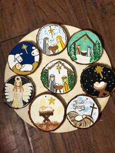 six decorated cookies sitting on top of a wooden table