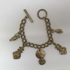 This is: An original vintage charm bracelet from the 60/70s. Lovely heavyweight gold tone brass curb bracelet with egraved ancient instrument, fish, urn and disc charms, fastening with a toggle clasp. Please see pics for size/weight/condition. Condition:  Great, no flaws. Any questions, please message me, thanks. I accept all returns - if you are not happy with your item, please message me before leaving feedback and I will be happy to deal with your concerns. I try my best to be as accurate as possible in my listings, but occasionally I will make a genuine mistake and will rectify it very quickly, just let me know, thanks. Vintage Charm Brass Bracelet, Bohemian Gold Charm Bracelet In Brass, Bohemian Gold Brass Charm Bracelet, Gold Engraved Metal Charm Bracelet, Engraved Gold Metal Charm Bracelet, Gold-tone Brass Charm Bracelet With Lobster Clasp, Bohemian Gold Charm Bracelet With Lobster Clasp, Gold Bohemian Charm Bracelet With Lobster Clasp, Bohemian Gold Metal Charm Bracelet