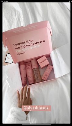 a woman's hand is reaching into a pink box that says, i would stop buying skincare but not a day