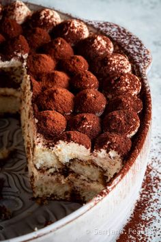 a cake that has been cut in half and is on a plate with powdered sugar