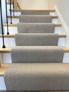 a set of stairs with carpeted treading and handrails