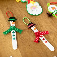 paper snowman and santa clause ornament on wooden table