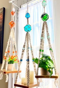 three macrame plant hangers in front of a window