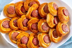 a white plate topped with pigs in a blanket