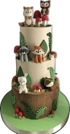 a three tiered cake with woodland animals on top