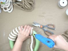 someone is working with rope and scissors on the table