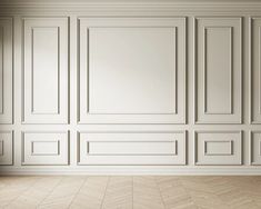 an empty room with white paneled walls and wood flooring is pictured in this image