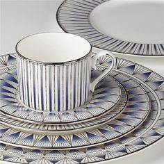 a set of blue and white dinnerware with an intricate design on the rims