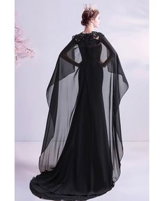 Buy stunning black flowy formal prom dress with cape sweet train at wholesale price online. Free shipping and pro custom service since 2009. Formal Witch Outfit, Black Flowy Dress Long, Dress With Cape Gowns, Black Fitted Prom Dress, Black Fantasy Gown, Dark Fantasy Dress, Black Dress With Cape, Prom Dress With Cape, Hot Villain