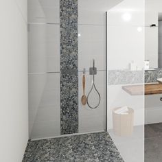 a bathroom with a walk in shower next to a sink