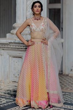 Featuring a fuchsia and yellow ombre lehenga in organza base with leheriya print and embroidery. It is paired with a contrasting off-white malai chanderi blouse having hand embroidery, a cutdana embroidered belt, and a net dupatta.  FIT: Fitted at bust and waist. COMPOSITION: Organza, Malai chanderi, Net. CARE: Dry clean only. Leheriya Lehenga, Multi Color Lehenga, Ombre Lehenga, Tassel Dupatta, Paulmi And Harsh, Chanderi Dupatta, 1950’s Fashion, Organza Blouse, Yellow Ombre