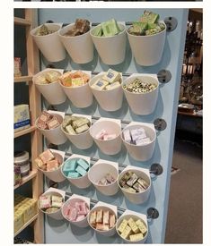 several buckets filled with different types of food on display in a store or restaurant