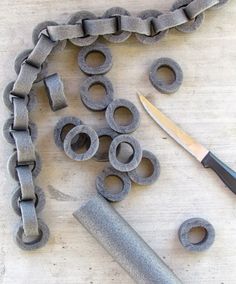 an image of some metal parts on a table with a pair of scissors and a knife