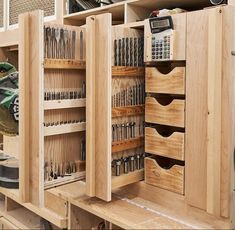 a workbench with many drawers and tools in it's storage compartment,