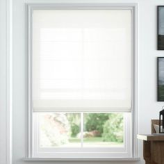 an empty room with white walls and windows that have blinds on the window sill