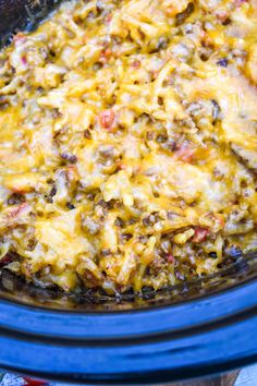 a crock pot filled with some taco meat and cheese on top of it