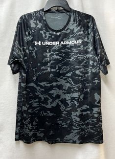 This is for a new with tags Under Armour Tech Camo short sleeve tee for a man.  The size is a men's large.   The color is a gray and black camo.  - Measurement across the chest: 22 inches - Measurement around the chest: 44 inches - Measurement from top of shoulder to bottom: 28.5 inches in the front and 30.5 inches in the back  Comes from a smoke free home.  Once payment has been received I will ship out the same day or the next morning. Thanks for looking. Seller's ID # E278 Gray Moisture-wicking Short Sleeve T-shirt, Camouflage Short Sleeve Sports Top, Under Armour Crew Neck T-shirt With Logo, Gray Short Sleeve Top For Outdoor, Under Armour Gray Crew Neck Top, Under Armour Short Sleeve T-shirt With Letter Print, Under Armour Black T-shirt For Streetwear, Under Armour Black Outdoor Tops, Black Short Sleeve T-shirt For Outdoor