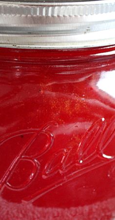 a close up view of a red mason jar