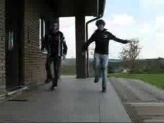 two young men are skateboarding down the sidewalk