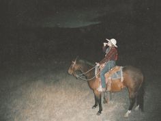 a man riding on the back of a brown horse