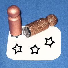 a rubber stamp with stars on it and a rolling pin in the middle to spell out star shapes