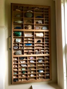 a wooden shelf filled with lots of rocks