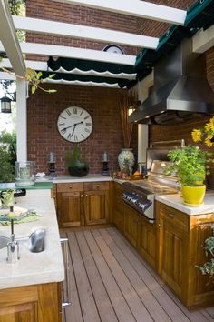 an outdoor kitchen with a clock on the wall