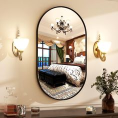 there is a mirror on the wall above a bed