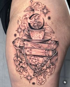 a woman's thigh with tattoos on her legs and books in the shape of a clock