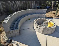 a fire pit built into the side of a concrete wall