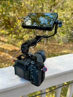 a camera attached to a tripod on a balcony