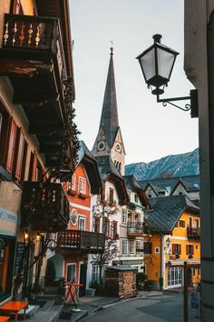 an old european street with buildings and a church steeple