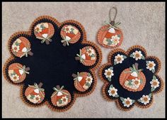 three pieces of fabric with flowers and pumpkins on them