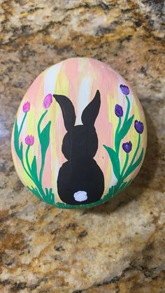 a painted rock with an image of a rabbit on it