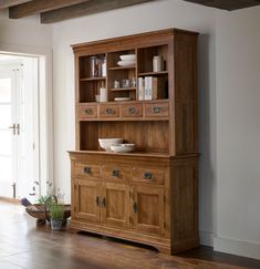 a wooden hutch sitting on top of a hard wood floor