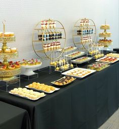 a table topped with lots of desserts and pastries