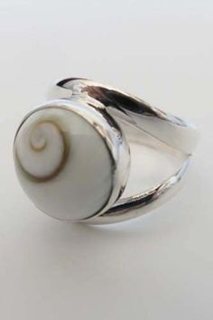 Sterling silver ring set with hand polished shell. The spiral in the shell is naturally formed and is considered good luck and has great cultural significance in many countries such as Australia (the Fibonacci sequence) in New Zealand (the Koru) and in Ireland (the Triskelion).  NB** The shells we source are farmed and not taken from the ocean.  The snail in which they come from are a food source in parts of NZ and the shells are a byproduct. Please note sizes are US ring sizes.   I have the fol Handmade White Shell Rings, Unique Silver Shell Rings, Handmade Silver Round Shell, Leg Ring, Legs Ring, Shiva Eye, Spiral Shell, Celtic Ring, Sterling Silver Rings Set