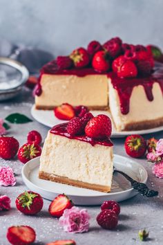 two slices of cheesecake with strawberries on the side