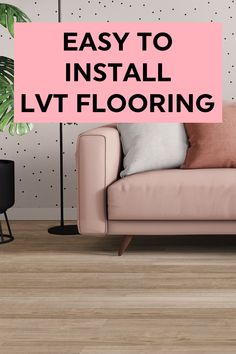 a living room with a pink couch and white polka dot wallpaper, the words easy to install lvt flooring