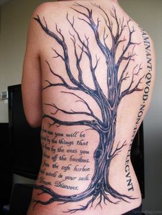 the back of a woman's body with a tree and poem tattooed on it