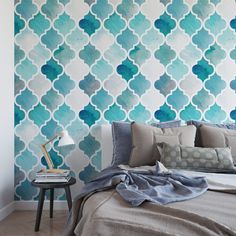 a bedroom with blue and white patterned wallpaper