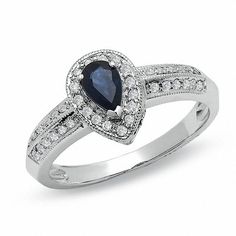 A taste of the classics, this vintage-enthused ring design wraps a remarkable 6.0 x 4.0mm pear-shaped sapphire in sparkling diamonds. The deep blue glow illuminates in a 10K white gold setting. With diamonds accenting the shank, this ring becomes a display of beauty and artistry. Sapphire is September's precious and beloved birthstone. Chocolate Diamond Ring Engagement, Zales Engagement Rings, Vintage Style Engagement Rings, Gold Diamond Wedding Band, Vintage Style Rings, Aquamarine Engagement Ring, Sapphire Engagement Ring Blue, Sapphire Engagement, Engagement Rings Sapphire