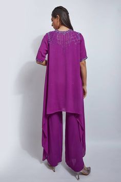 Violet double georgette kurta with cutdana hand embroidered yoke and sleeve hems. Comes with palazzo and an organza dupatta.
Components: 3
Pattern: Hand embroidered
Type Of Work: Cutdana
Neckline: Round
Sleeve Type: Half
Fabric: Double georgette, Dupatta: Organza
Color: Purple
Other Details: 
Attached lining
Length:
Kurta: 34 inches
Sleeves: 11 inches
Pant: 40 inches
Model Height: 5ft 5.6inches, wearing size M
Occasion: Sangeet - Aza Fashions Georgette Kurta, Kurta Palazzo Set, Georgette Dupatta, Types Of Work, Palazzo Set, Organza Dupatta, Set For Women, Aza Fashion, Model Height