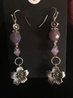 a pair of earrings sitting on top of a display