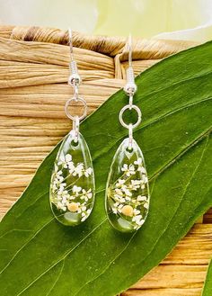 Share your faith and spread the joy everywhere you go! These delicate teardrop earrings have wildflowers and one single mustard seed in each earring. They are a reminder that all you need is the tiniest bit of faith in order to move a mountain.  Perfect for any occasion, a gift for a friend, or just a reminder of your own faith in God.  Earrings are handmade with resin, real flowers, mustard seeds, and sterling silver hypoallergenic wires.  The beautiful thing about resin earrings is how lightwe Nature-inspired Teardrop Birth Flower Earrings, Hypoallergenic Flower Teardrop Earrings For Gift, White Teardrop Hypoallergenic Flower Earrings, White Teardrop Flower Earrings, White Teardrop Earrings For Mother's Day, Faith Earrings, Mustard Seed Jewelry, Wedding Flower Jewelry, Flower Resin Jewelry