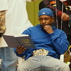 a man sitting in a chair reading a book