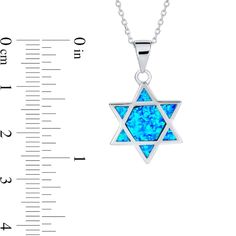 Vibrant and fun, this blue lab-created opal Star of David pendant is a casual display of your faith you can wear with everything. Fashioned in sterling silver This Star of David design glistens with iridescent blue lab-created opal cabochon inlays - a hexagon-shaped center surrounded by triangle shapes along the sides. This pendant suspends along an 18.0-inch rolo chain that secures with a spring-ring clasp. Silver Star Of David Birthstone Jewelry, Silver Star Of David Jewelry With Birthstone, Blue Sterling Silver Star Of David Necklace, Blue Star Of David Jewelry Gift, Sterling Silver Jewelry For Hanukkah Gifts, Star Of David Pendant, Iridescent Blue, Star Of David, Rolo Chain