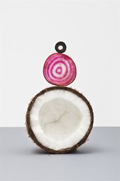 a red onion sitting on top of a coconut